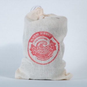 A canvas drawstring bag with red Lax Wax warm water logo stands upright against a white background, with the gathered top visible and natural fabric texture showing through.